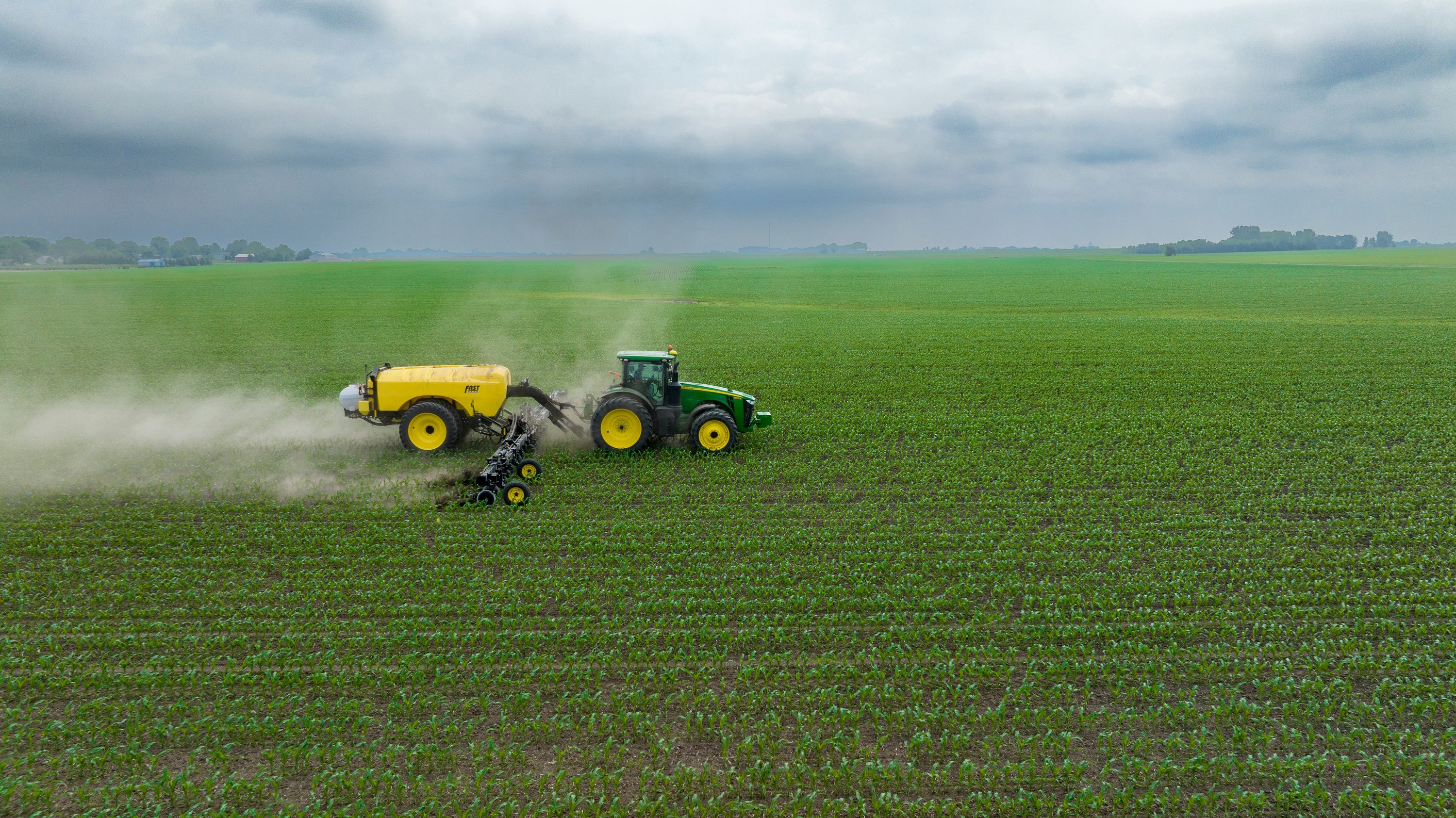 Aerial tractor spraying field